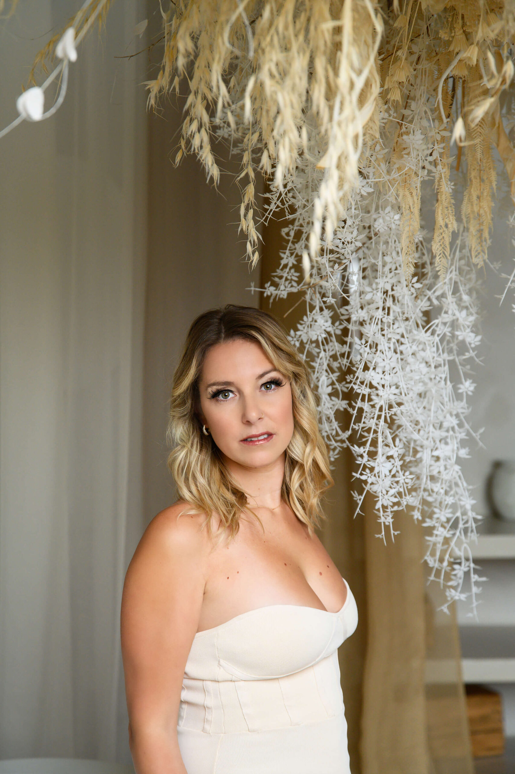 Blonde woman with pampas around for her Toronto boudoir photography session. Best hair salons Toronto.